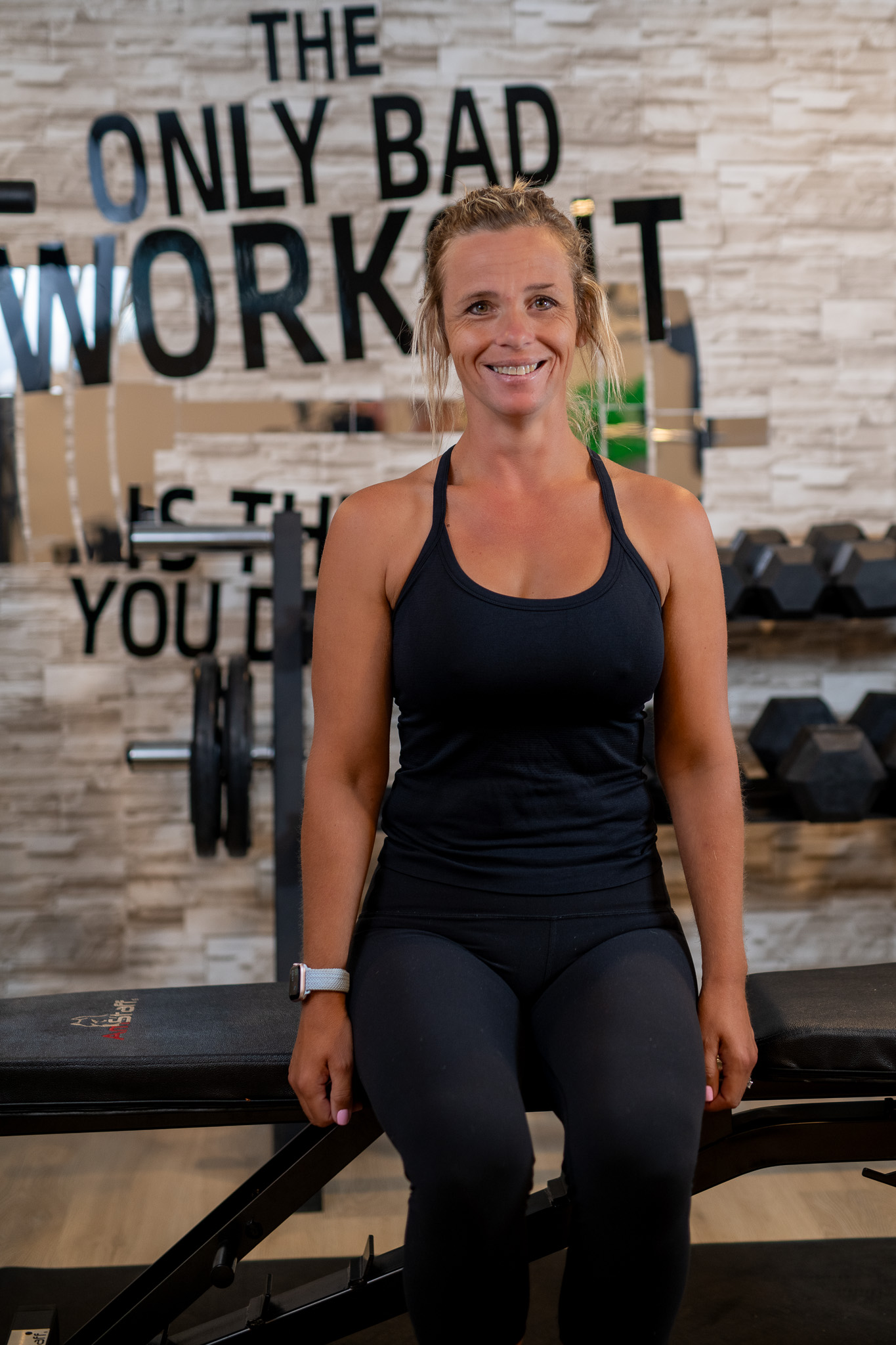 Erin seated in her studio with her arms resting straight beside her